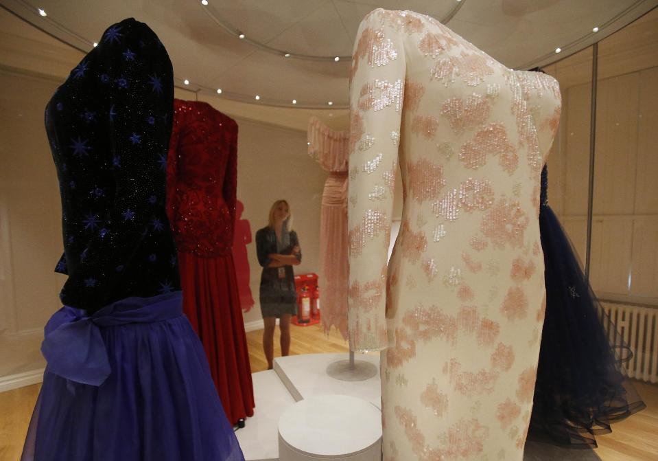 In this photo taken Monday, July 1, 2013, dresses of Princess Diana are displayed at the Fashion Rules exhibition at Kensington Palace in London, Monday, July 1, 2013. Opening on 4 July, a new glamorous exhibit at Kensington Palace showcases how the styles of three royal ladies; Queen Elizabeth II, her sometimes risque sister Margaret, and the glamorous Princess Diana, each reflected and influenced the trends of their fashion heyday. (AP Photo/Frank Augstein)