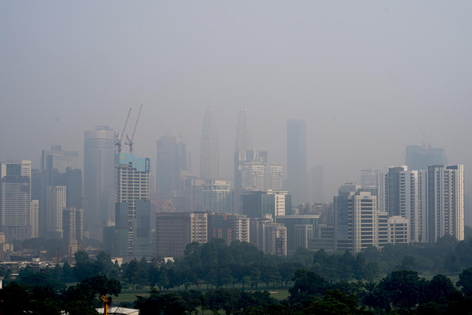 Kuala Lumpur city stands shrouded with haze in Kuala Lumpur, Malaysia, Tuesday, Sept. 17, 2019. More than 100 schools were closed Tuesday after the air quality in the area continued to trend at very unhealthy levels. (AP Photo/Vincent Thian)