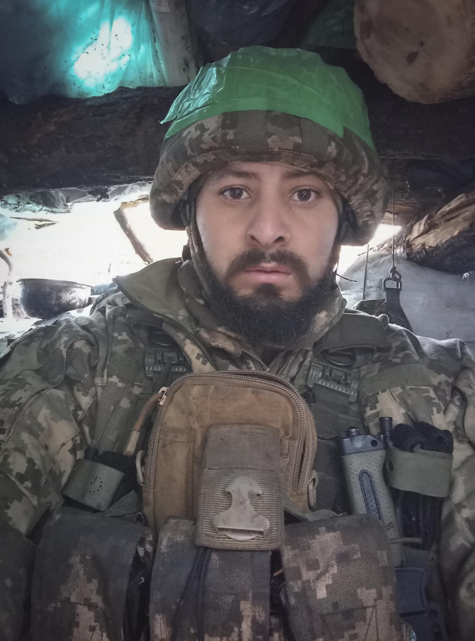 This 2023 photo provided by a 32-year-old professional soldier from Medellín, Colombia who goes by the call sign Checho shows him in his combat gear in Donbas, eastern Ukraine. Checho says he was struck by fire from a drone during a rescue operation to save a wounded colleague on the front line after three days of heavy fighting with Russian forces. At the hospital in the Kyiv region, Checho found himself with more than fifty other Colombians, most with light injuries sustained while flighting Russian occupation forces in eastern Ukraine’s Donetsk region. They are among hundreds of Colombian veterans who have made the journey to Ukraine to help its forces fight the Russians. (Courtesy of Checho via AP)