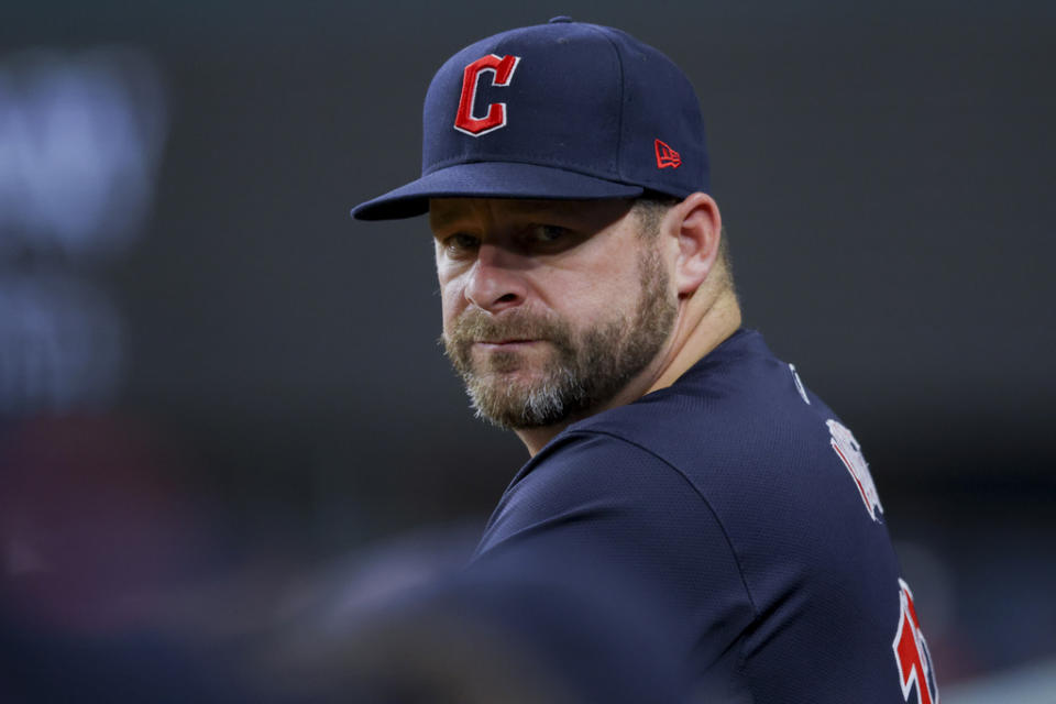 Cleveland Guardians manager Stephen Vogt looks into the dugout during the sixth inning of a baseball game against the Texas Rangers, Monday, May 13, 2024, in Arlington, Texas. (AP Photo/Gareth Patterson)