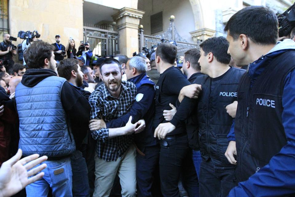 Police block protesters as they gather outside the parliament building in Tbilisi, Georgia, on Tuesday, April 16, 2024, to protest against "the Russian law" similar to a law that Russia uses to stigmatize independent news media and organizations seen as being at odds with the Kremlin. (AP Photo/Shakh Aivazov)