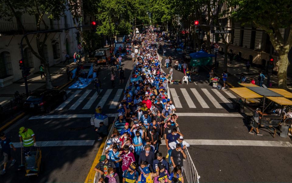 Fans of late Diego Maradona make a line pass in front of his coffin at Casa Rosada  - Tomas Cuesta 