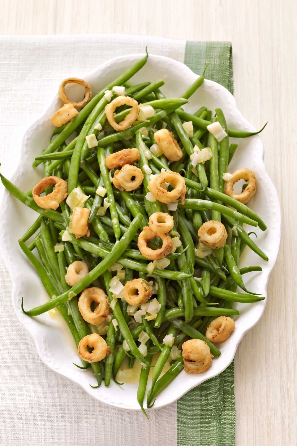 <p>Put a new spin on this traditional casserole by opting for fresh ingredients.</p><p><strong><a href="https://www.countryliving.com/food-drinks/recipes/a3083/french-green-beans-butter-sauce-crispy-leeks-recipe/" rel="nofollow noopener" target="_blank" data-ylk="slk:Get the recipe;elm:context_link;itc:0;sec:content-canvas" class="link ">Get the recipe</a>.</strong></p>