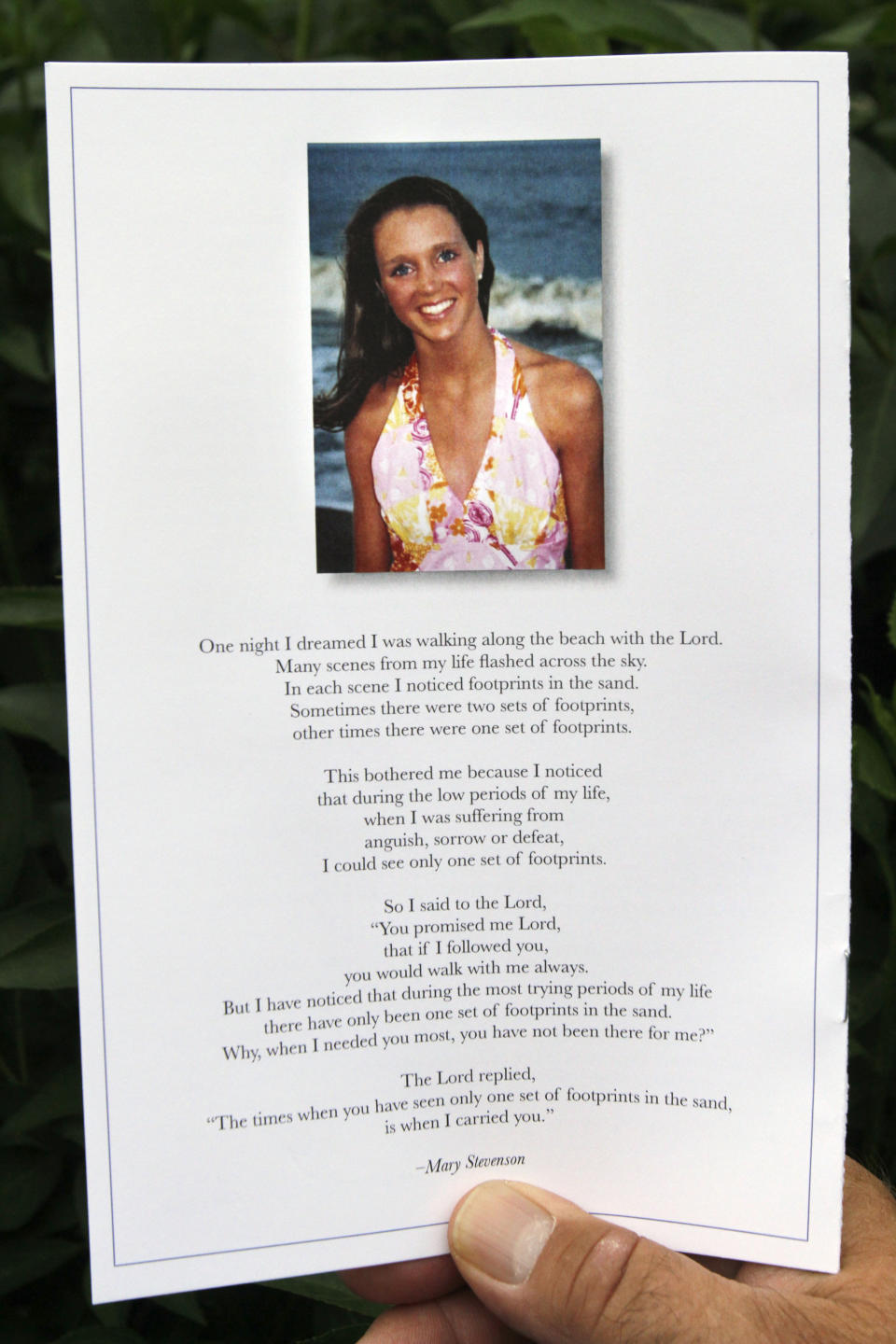 FILE - A person holds a program for the funeral of slain University of Virginia lacrosse player Yeardley Love in Baltimore, Md., on Saturday, May 8, 2010. Nearly 12 years after Love was found dead, George Huguely, convicted of second-degree murder in her killing is headed back to court for a civil trial. Jury selection is expected in Charlottesville Circuit Court Monday, April 25, 2022 in a trial that will seek to hold George Huguely V liable in the death of Love. (AP Photo/Jacquelyn Martin, File)