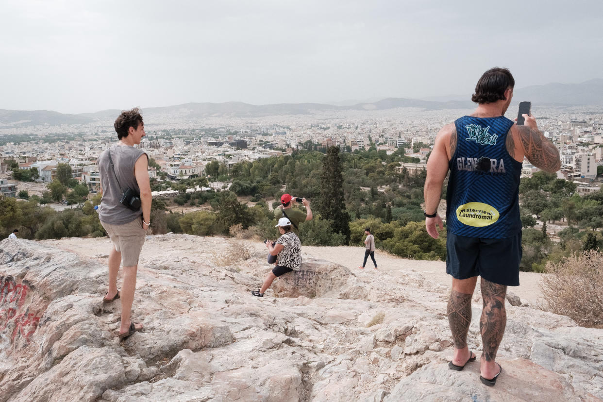 Europe Tourists are visiting a viewing site beneath the Acropolis ancient ruin during high temperatures in Athens, Greece, on June 13, 2024. (Photo by Nikolas Kokovlis/NurPhoto via Getty Images)