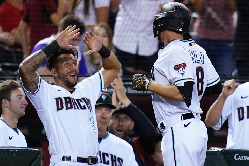 Arizona Diamondbacks' Jordan Luplow (8) celebrates his three-run home run against the Kansas City Royals with Diamondbacks' David Peralta (6) during the sixth inning of a baseball game Tuesday, May 24, 2022, in Phoenix. (AP Photo/Ross D. Franklin)