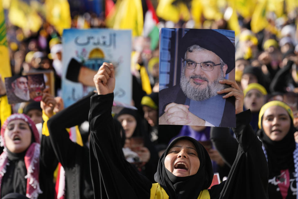 Supporters of the Iranian-backed Hezbollah group shout slogans, as they wait the speech of Hezbollah leader Sayyed Hassan Nasrallah, during a rally to commemorate Hezbollah fighters who were killed in South Lebanon last few weeks while fighting against the Israeli forces, in Beirut, Lebanon, Friday, Nov. 3, 2023. Nasrallah's speech had been widely anticipated throughout the region as a sign of whether the Israel-Hamas conflict would spiral into a regional war. (AP Photo/Hussein Malla)
