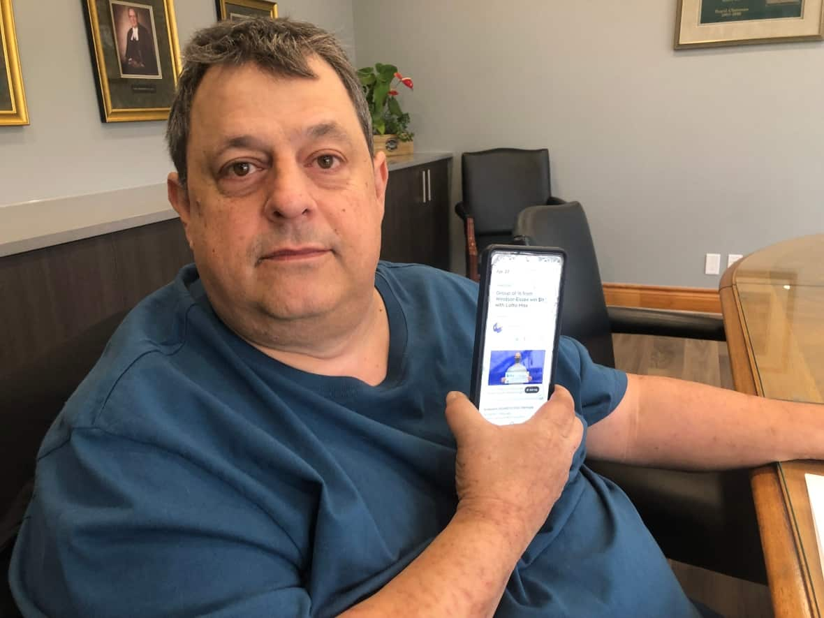 Philip Tsotsos of Windsor, Ont., claims he was wrongfully cut out of his work group's lottery pool that netted them $1 million from a ticket last summer. The pizza delivery worker says seeing his old boss holding a million-dollar cheque on social media 'hurt more than anything.' (Jacob Barker/CBC - image credit)