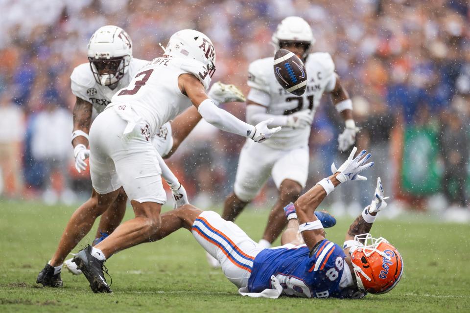 Sep 14, 2024; Gainesville, Florida, USA; Florida Gators wide receiver Marcus Burke (88) and Texas A&M Aggies defensive back Marcus Ratcliffe (3) battle for the ball during the first half at Ben Hill Griffin Stadium. Mandatory Credit: Matt Pendleton-Imagn Images