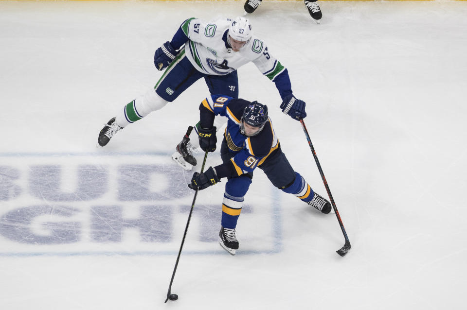 Vancouver Canucks' Tyler Myers (57) chases St. Louis Blues' Vladimir Tarasenko (91) during the second period in Game 1 of an NHL hockey Stanley Cup first-round playoff series, Wednesday, Aug. 12, 2020, in Edmonton, Alberta. (Jason Franson/The Canadian Press via AP)