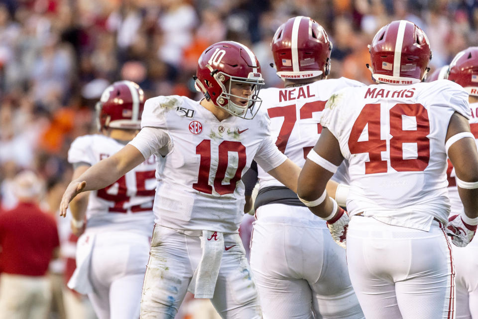 Alabama quarterback Mac Jones (10) greets teammates after an extra point against Auburn during the first half of an NCAA college football game, Saturday, Nov. 30, 2019, in Auburn, Ala. (AP Photo/Vasha Hunt)