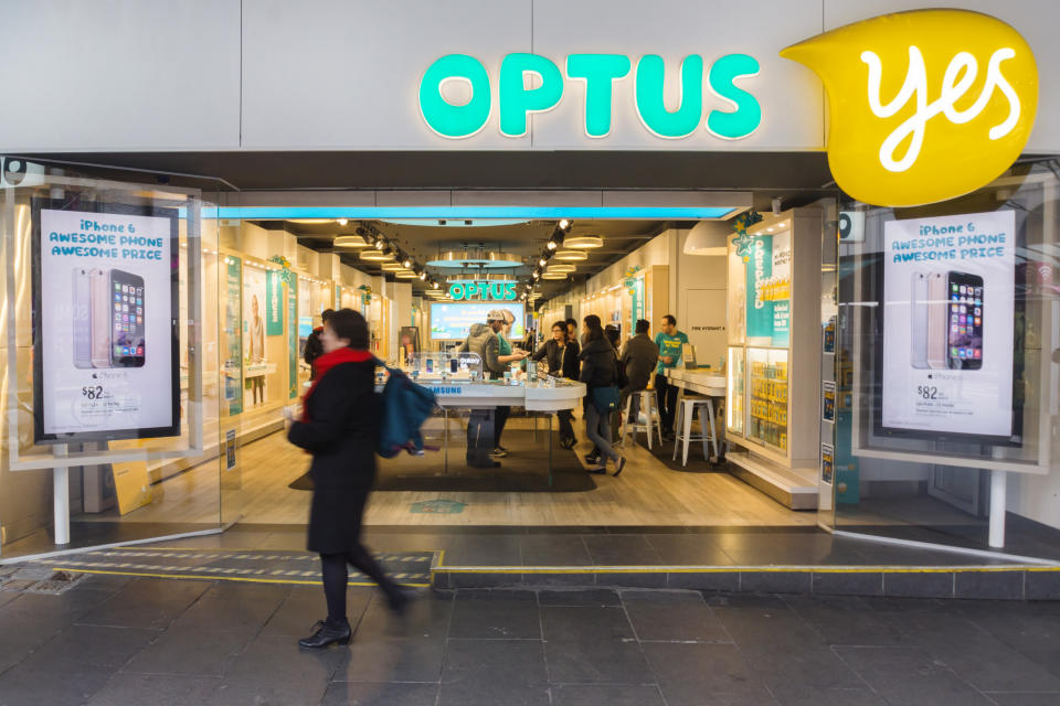 Melbourne, Australia - August 6, 2015: A woman walks past an Optus store on Bourke St. Optus is the second largest telecommunications company in Australia.