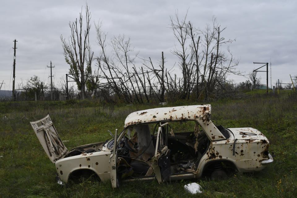 A Russian-made Lada car damaged by fighting in the village of Dolyna, Donetsk region, Ukraine, Thursday, Nov. 3, 2022. (AP Photo/Andriy Andriyenko)