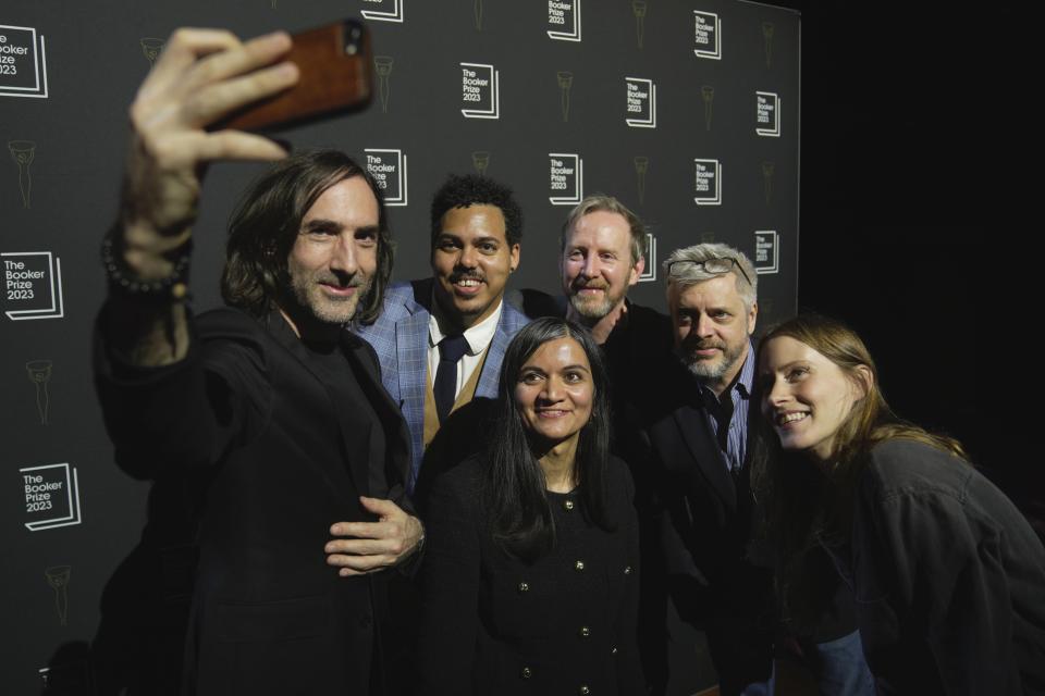 From left, Irish author Paul Lynch, American author Jonathan Escoffery, British author Chetna Maroo, Irish author Paul Murray, American author Paul Harding and Canadian author Sarah Bernstein take a selfie during a photocall for the Booker Prize 2023, in London, Thursday, Nov. 23, 2023 ahead of the award ceremony on Nov. 26 in London. (AP Photo/Kin Cheung)