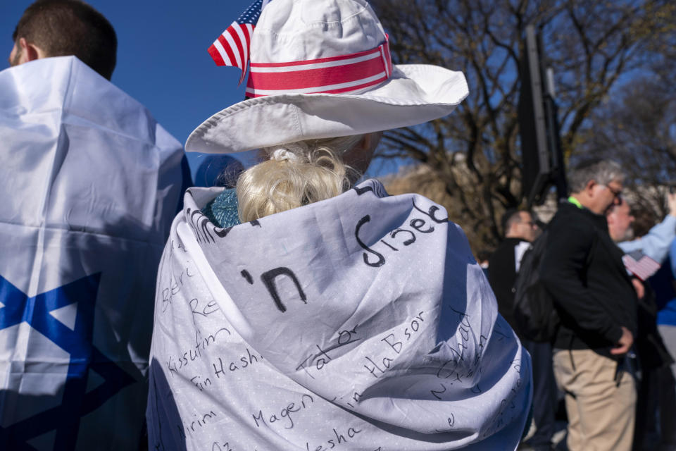 A woman wears a cloth listing the names of Israeli Kibbutzes that were attacked by Hamas on Oct. 7, while attending the March for Israel rally Tuesday, Nov. 14, 2023, on the National Mall in Washington. (AP Photo/Jacquelyn Martin)