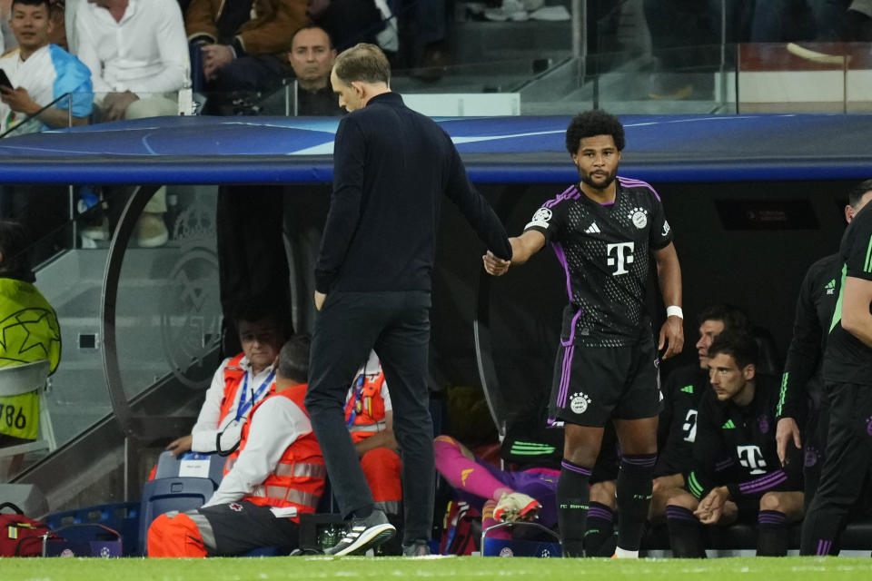 Bayern's Serge Gnabry, left, shakes hand to his coach Thomas Tuchel during the Champions League semifinal second leg soccer match between Real Madrid and Bayern Munich at the Santiago Bernabeu stadium in Madrid, Spain, Wednesday, May 8, 2024. (AP Photo/Jose Breton)