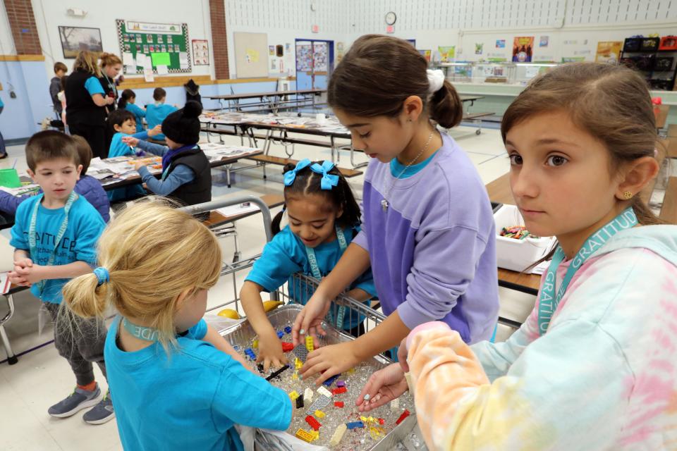 Students from different grades in the house of Gratitude work together on a task at Carrie E. Tompkins Elementary School in Croton Nov. 17, 2023. Students in grades K-4 are divided into eight groups or "houses" and once a month they come together to work on different projects together.