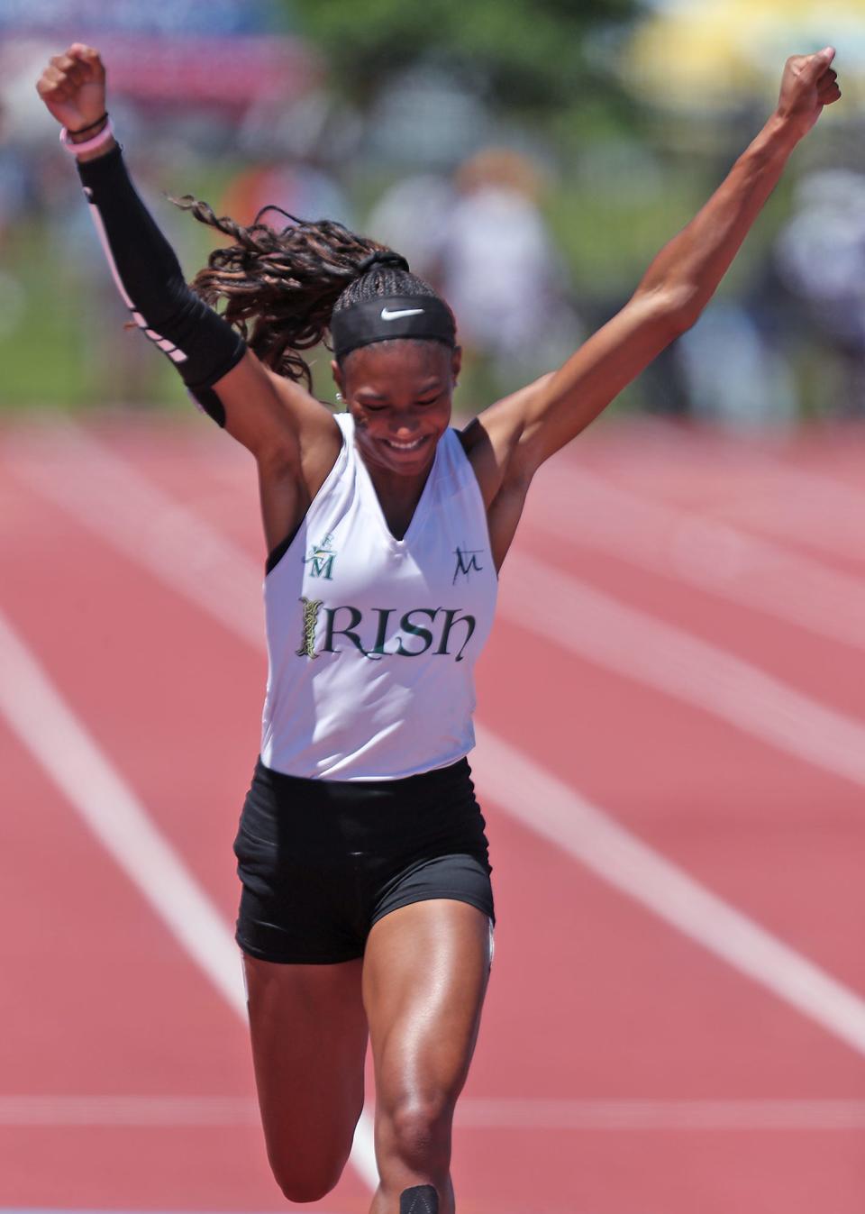 St. Vincent-St. Mary's Kya Epps celebrates as she sets a new state record with a time of 23.81 and a championship in the 200 meter dash at the Div. II state track and field championships at Jesse Owen Stadium in Columbus on Saturday.