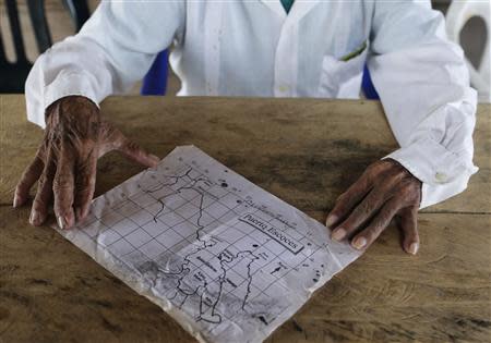 A map of Puerto Escoces (Scottish Harbour) is shown by Caledonia's chief Aristoteles Cabu on Caledonia island in the region of Guna Yala April 5, 2014. REUTERS/Carlos Jasso