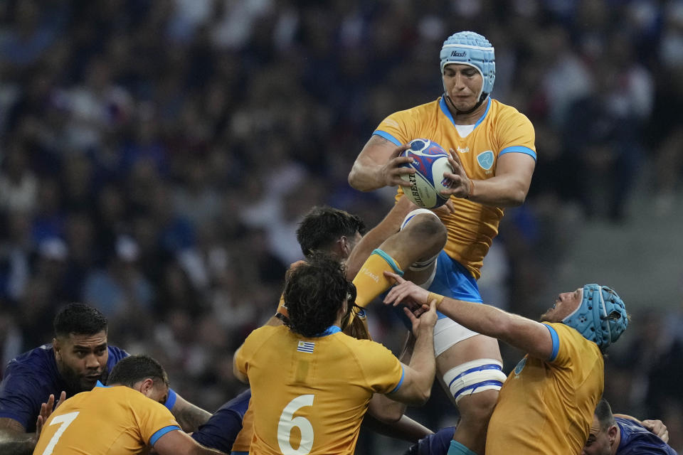 Uruguay's Felipe Aliaga, top, catches the ball during the Rugby World Cup Pool A match between France and Uruguay at the Pierre Mauroy stadium in Villeneuve-d'Ascq, near Lille, France, Thursday, Sept. 14, 2023. (AP Photo/Thibault Camus)