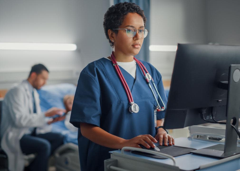 Nurse at terminal in hospital room.