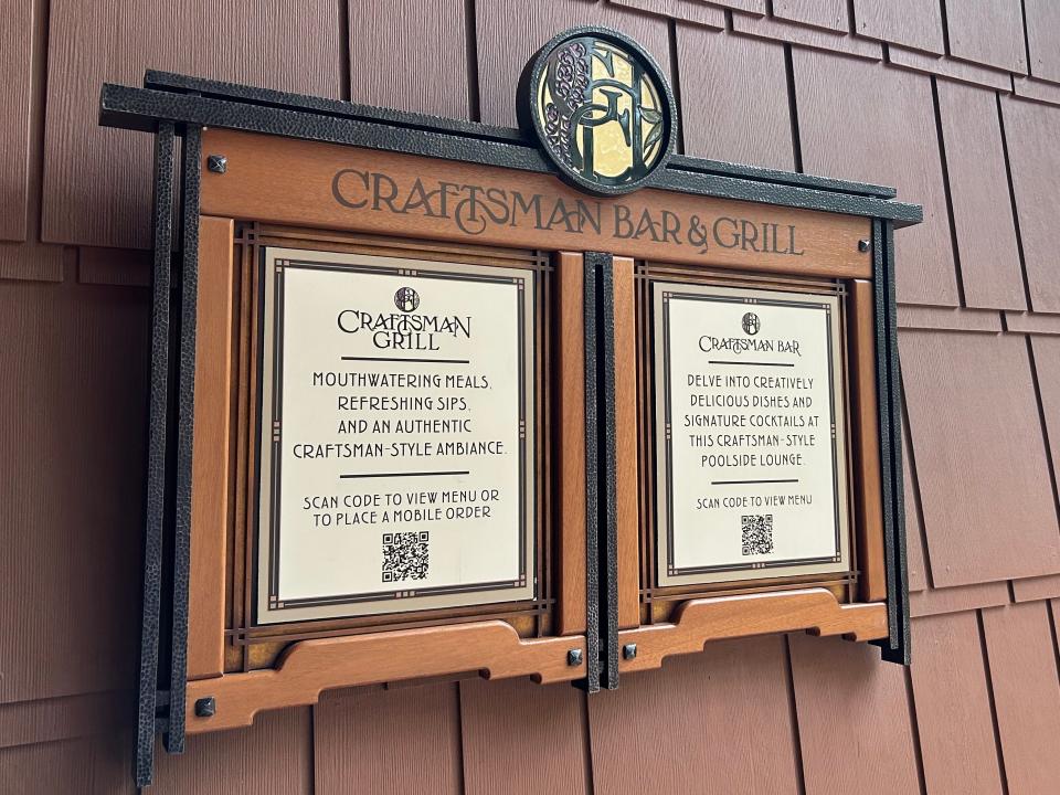 A sign for the Craftsman Bar and Grill with a QR code to scan to view the menu or place a mobile order.