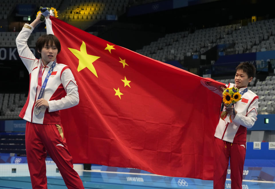 FILE - Chen Yuxi of China, left, silver medal and Quan Hongchan of China, gold medal react after winning gold medal in women's diving 10m platform final at the Tokyo Aquatics Centre at the 2020 Summer Olympics, on Aug. 5, 2021, in Tokyo, Japan. Chinese divers are focused on winning all eight gold medals at the Paris Olympics. The Chinese have dominated the sport for decades but have never won every gold medal in diving in a single Olympics. (AP Photo/Dmitri Lovetsky, File)