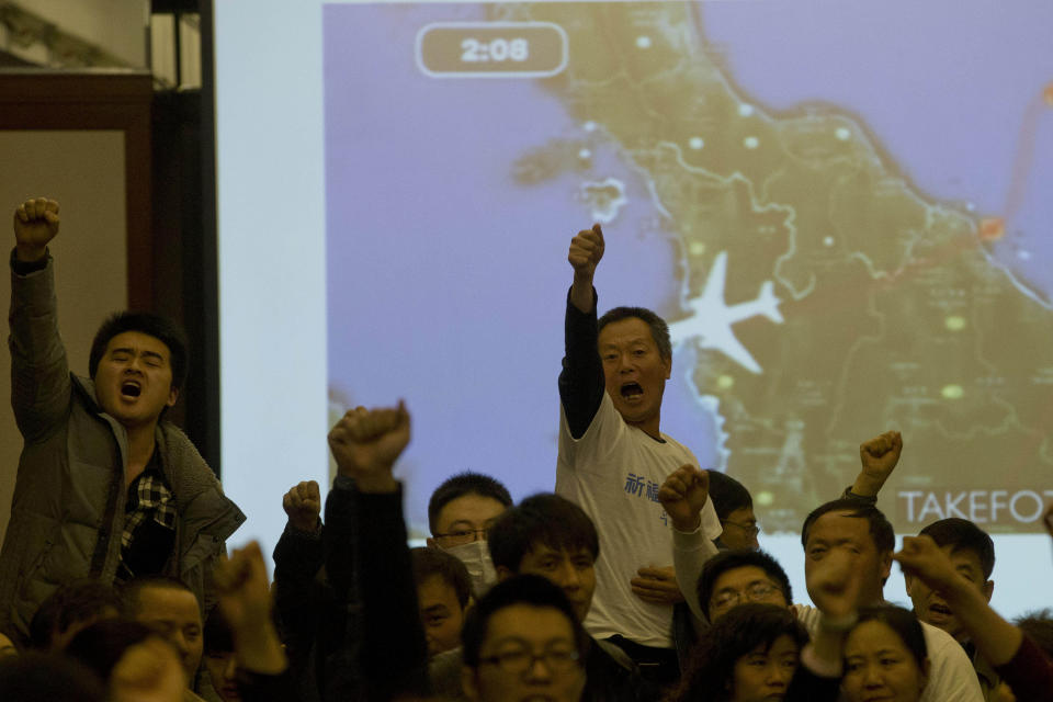 Relatives of Chinese passengers aboard the missing Malaysia Airlines, flight MH370, turn to journalists to shout their demands for answers after Malaysian government representatives left a briefing in Beijing, China. Authorities have been forced on the defensive by the criticism, the most forceful of which has come from a group of Chinese relatives who accuse them of lying about - or even involvement in - the disappearance of Flight 370. (AP Photo/Ng Han Guan, File)