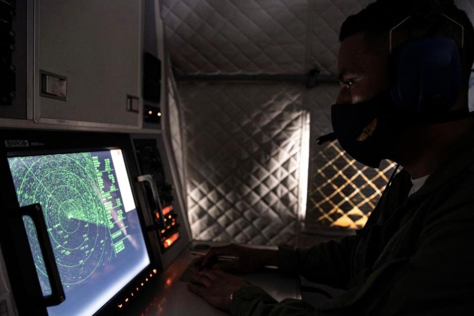 An Ecuadorian navy officer looks at a radar after the mostly Chinese-flagged fleet was detected in an international corridor that borders the Galápagos Islands.