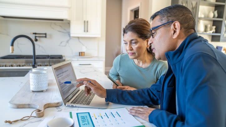 A married couple looks over their financial plan for retirement. 