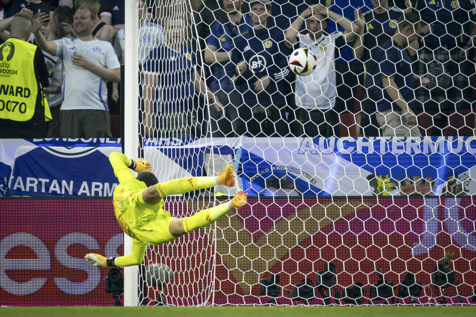 FILE - Scotland's goalkeeper Angus Gunn is unable to stop a shot for a goal by Switzerland's Xherdan Shaqiri during a Group A match between Scotland and Switzerland at the Euro 2024 soccer tournament in Cologne, Germany, Wednesday, June 19, 2024. A high-tech soccer ball that helps with more accurate offside decisions will make its European Championship debut next year in Germany after being used at the 2022 World Cup. (Peter Klaunzer/Keystone via AP, File)