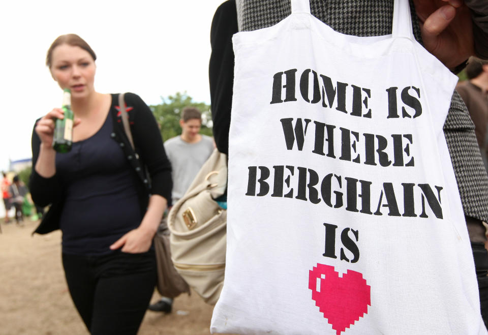 BERLIN, GERMANY - JULY 21: A visitor carries a cloth tote bag advertising the Berlin dance club Berghain during the second annual Hipster Olympics on July 21, 2012 in Berlin, Germany. With events such as the "Horn-Rimmed Glasses Throw," "Skinny Jeans Tug-O-War," "Vinyl Record Spinning Contest" and "Cloth Tote Sack Race," the Hipster Olympics both mocks and celebrates the Hipster subculture, which some critics claim could never be accurately defined and others that it never existed in the first place. The imprecise nature of determining what makes one a member means that the symptomatic elements of adherants to the group vary in each country, but the archetype of the version in Berlin, one of the more popular locations for those following its lifestyle, along with London and Brooklyn, includes a penchant for canvas tote bags, the carbonated yerba mate drink Club Mate, analogue film cameras, asymmetrical haircuts, 80s neon fashion, and, allegedly, a heavy dose of irony. To some in Berlin, members of the hipster "movement" have replaced a former unwanted identity in gentrifying neighborhoods, the Yuppie, for targets of criticism, as landlords raise rents in the areas to which they relocate, particularly the up-and-coming neighborhood of Neukoelln. (Photo by Adam Berry/Getty Images)