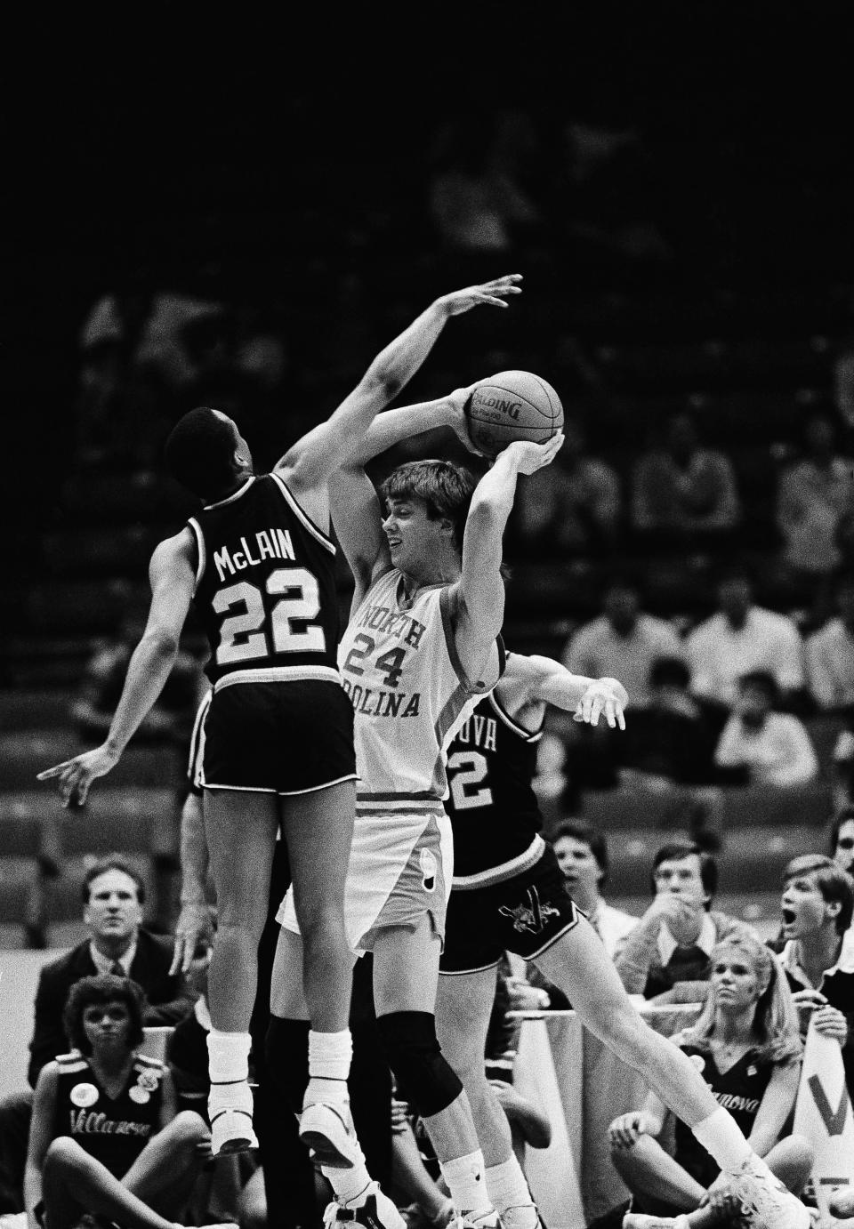 North Carolina’s Joe Wolf (24) is stopped by Villanova players Gary McLain (22) and Harold Jensen (32) during early action at NCAA Southeast Regional finals at Birmingham, Alabama, March 24, 1985. AP Photo