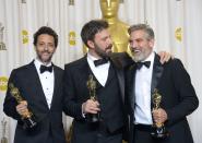 Ben Affleck (C), George Clooney (R) and Grant Heslov celebrate in the press room after winning the trophy for Best Picture for "Argo" during the Oscars on February 24, 2013 in Hollywood, California