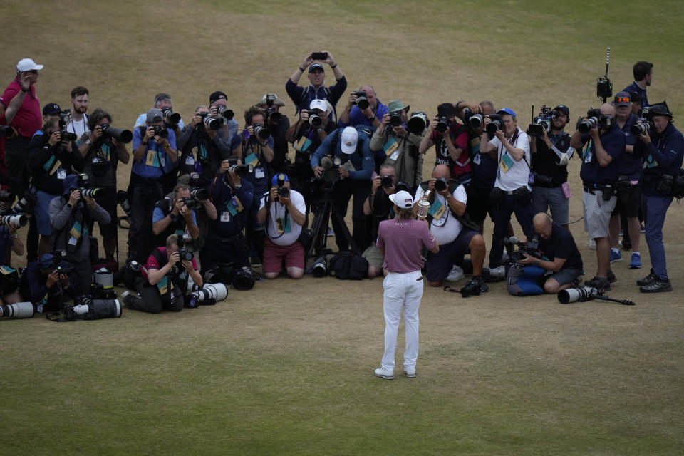 Cameron Smith, of Australia, holds the claret jug on the 18th green after winning the British Open golf championship on the Old Course at St. Andrews, Scotland, Sunday July 17, 2022.(AP Photo/Alastair Grant)