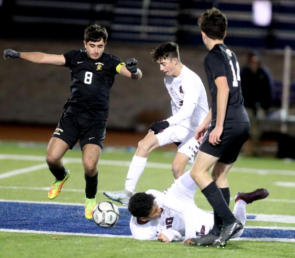 Nicolas Galeano of Scarsdale hits the turf while battling for the ball iagainst McQuaid Jesuit in the New York State Class AA Soccer Championship at Middletown High School Nov. 13, 2022. Scarsdale defeated McQuad Jesuit 2-0.