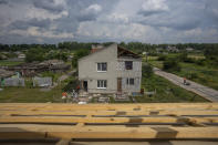 Civilians rebuild their homes after being destroyed by Russian strikes, Yahidne village, northern Chernihiv region, Ukraine, Wednesday, June 29, 2022. A few months after Russian troops retreated from Yahidne, the village has gradually returned to life. People are repairing their homes, and a strong wind occasionally picks up the bitter smell of ashes. (AP Photo/Nariman El-Mofty)