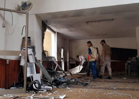 People inspect the damage inside a mosque following a twin bombing in Benghazi, Libya February 9, 2018. REUTERS/Stringer