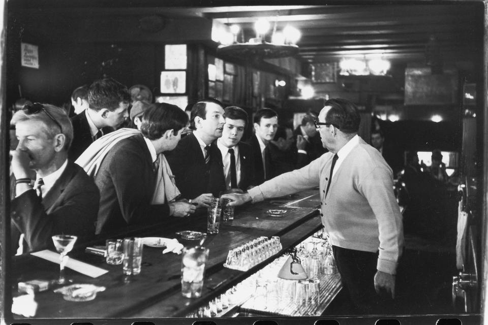 After pouring their drinks, a bartender in Julius's Bar refuses to serve (from left to right) John Timmins, Dick Leitsch, Craig Rodwell, and Randy Wicker, members of the Mattachine Society, who were protesting New York liquor laws that prevented serving gay customers, in New York, on April 21, 1966. | Fred W. McDarrah—Getty Images