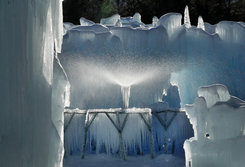 A sprinkler sprays a fine mist over a metal rack to grow icicles at Ice Castles in North Woodstock, N.H. Ice artists will harvest the icicles and use them to grow the castles' walls. (Photo: Robert F. Bukaty/AP)