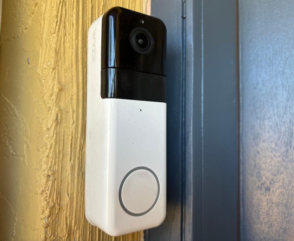 A Wyze doorbell camera is attached to the wall next to a user's front door.