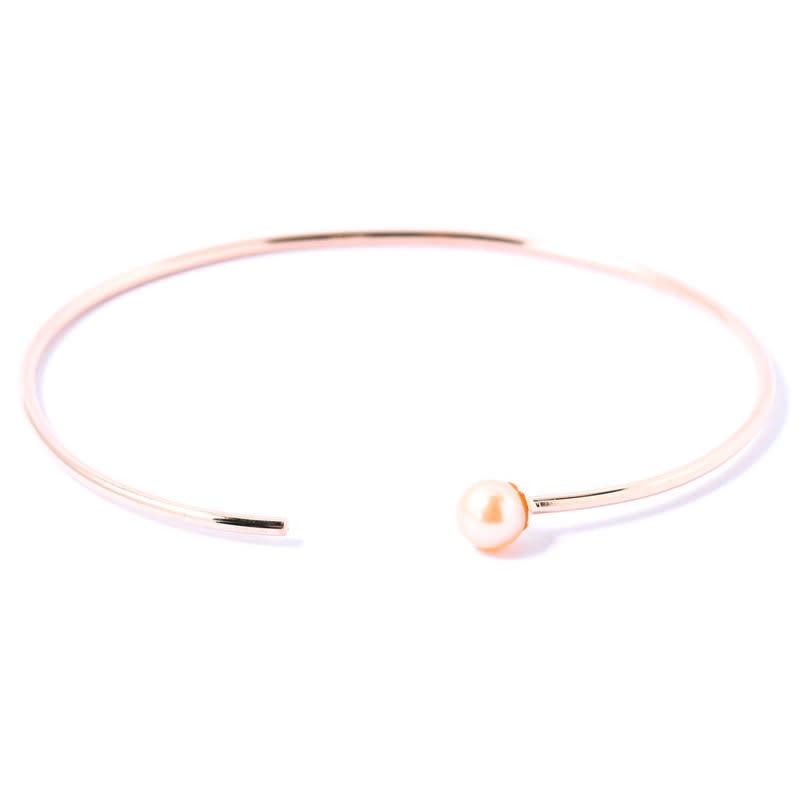 <p>Don’t be afraid to mix your metals! This rose-gold bangle pairs well with both silver and yellow gold, but it also looks stunning by itself.</p><p>Buy it <a rel="nofollow noopener" href="https://www.the9thmuse.com/en_us/summer-single-pearl-bangle-4564" target="_blank" data-ylk="slk:here;elm:context_link;itc:0;sec:content-canvas" class="link ">here</a> for $132.</p>