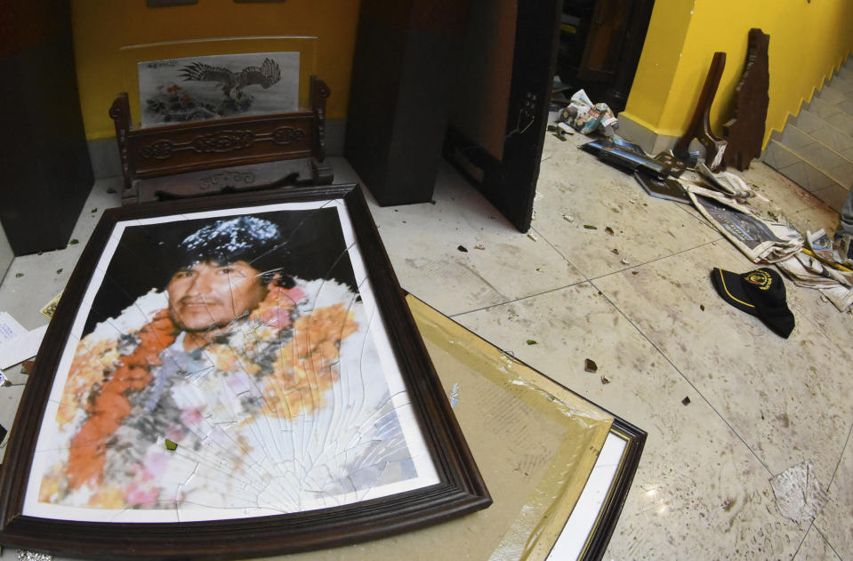 A broken portrait of former Bolivia's President Evo Morales is on the floor of his private home in Cochabamba, Bolivia, after hooded opponents broke into the residence on Sunday, Nov. 10, 2019. Morales resigned Sunday under mounting pressure from the military and the public after his re-election victory triggered weeks of fraud allegations and deadly protests. (AP Photo)