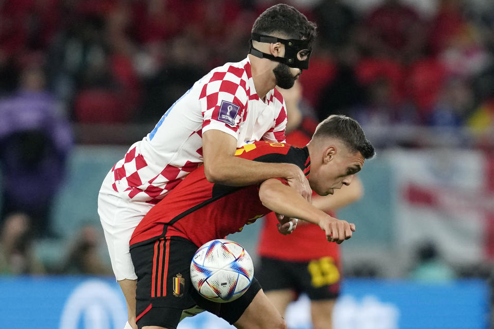 Croatia's Josko Gvardiol and Belgium's Leandro Trossard fight for the ball during the World Cup group F soccer match between Croatia and Belgium at the Ahmad Bin Ali Stadium in Al Rayyan, Qatar, Thursday, Dec. 1, 2022. (AP Photo/Thanassis Stavrakis)