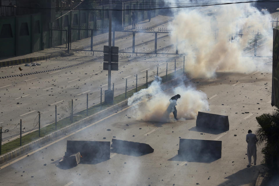 Police fire tear gas to disperse supporters of Pakistan's former Prime Minister Imran Khan protesting against the arrest of their leader, in Peshawar, Pakistan, Tuesday, May 9, 2023. Khan was arrested and dragged from court as he appeared there to face charges in multiple graft cases, a dramatic escalation of political tensions that sparked violent demonstrations by his supporters in major cities. (AP Photo/Muhammad Sajjad)