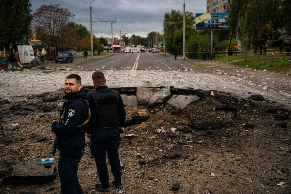 Investigators examine a crater following a missile strike in Dnipro (AFP/Getty)