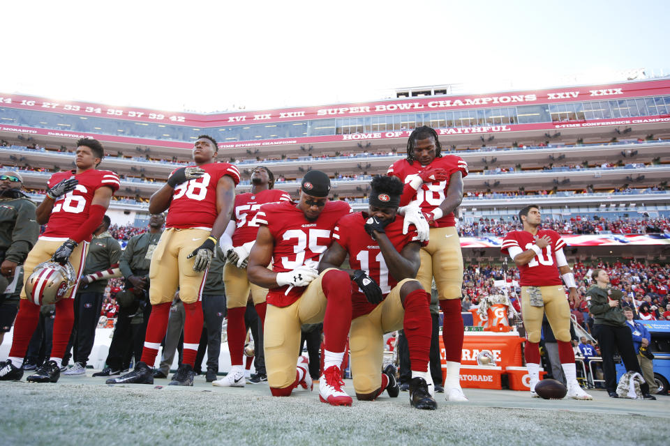 Reid, left, and teammate Marquise Goodwin, right,&nbsp;kneel during the anthem on Nov. 12, 2017, in Santa Clara, California. (Photo: Michael Zagaris via Getty Images)