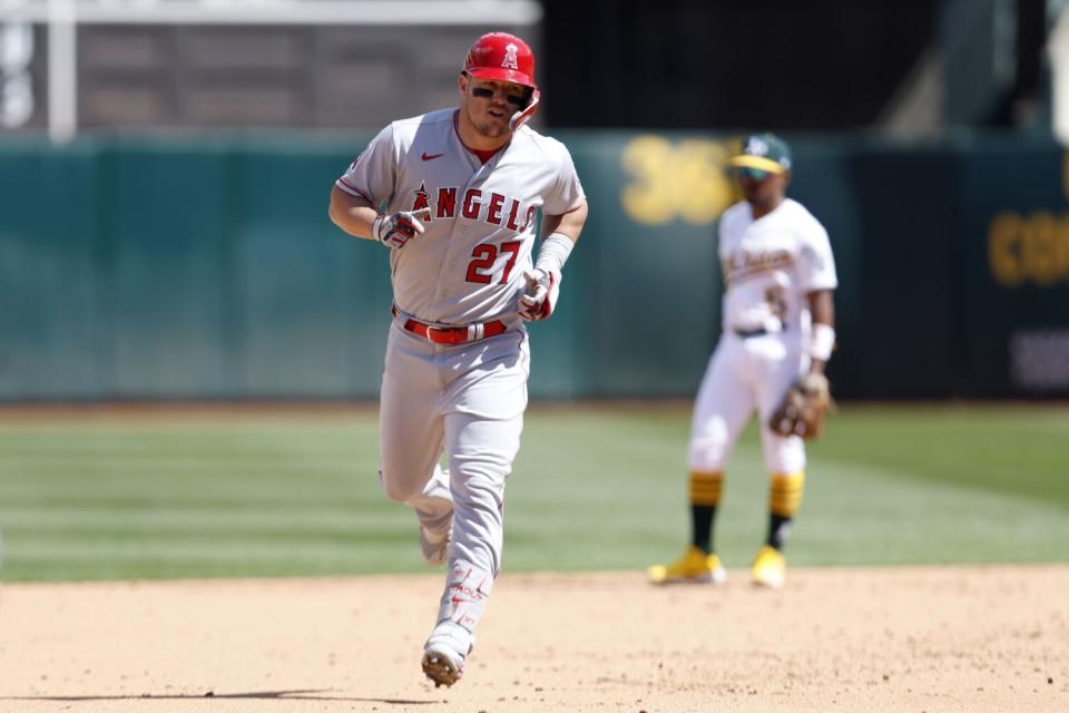 Angels center fielder Mike Trout rounds the bases after hitting a home run against the Oakland Athletics on Sunday.