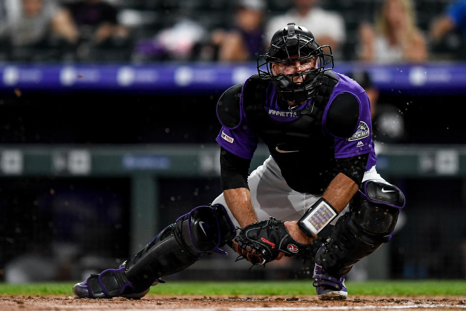 DENVER, CO - JULY 13:  Chris Iannetta #22 of the Colorado Rockies holds the ball attempting to apply a tag against the Cincinnati Reds  at Coors Field on July 13, 2019 in Denver, Colorado. (Photo by Dustin Bradford/Getty Images)