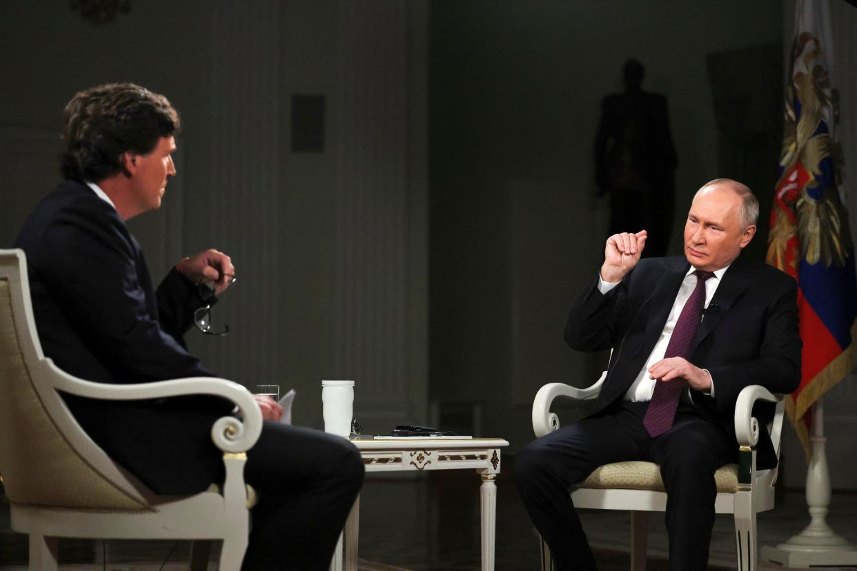 Russian President Vladimir Putin, right, speaks during an interview with former Fox News host Tucker Carlson at the Kremlin in Moscow (Sputnik)